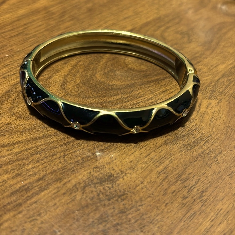 Goldtone / black enamel with crystal accents hinged bangle bracelet
